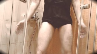 The guy dances in the shower to the music